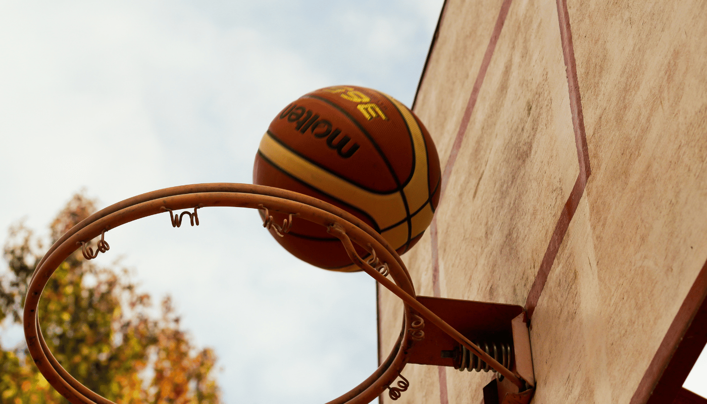 What was the first basketball hoop made of